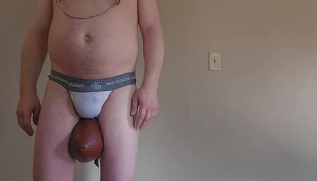 Football Bro Squeezes Football Between His Thighs and Pisses