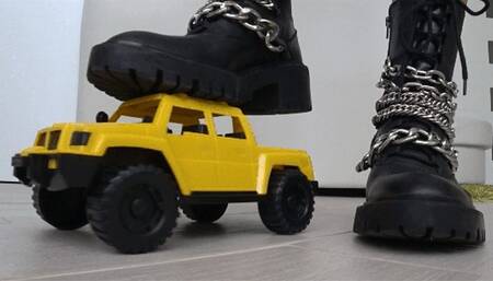 Crushed a toy car with black boots d