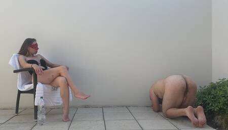 Mistress Anastasia Sunbathing with her slave