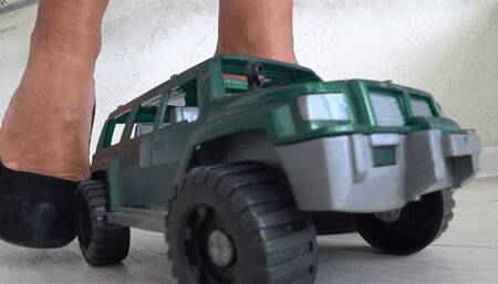 Crushed a toy car with black shoe with high heels a