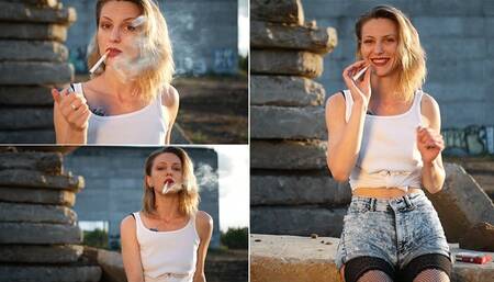 Sasha is smoking 3 reds in a row outdoors