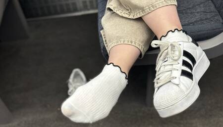 Candid sneaker removal and shoeplay on the busy train with an itchy foot