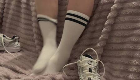 Itchy foot wearing sneakers and socks after a workout at the gym