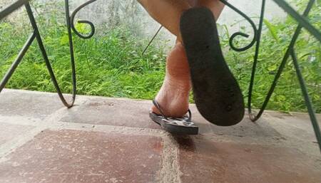 The soles of the feet while wearing flip-flops and seen from the back up close (3)