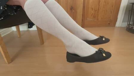 Shoeplay, dangling and dipping in white knee socks and ballet flats