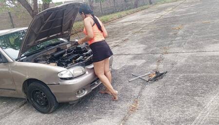 Woman repairs antique car using her feet to pump pedals (3)