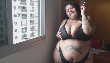 Bbw smoking in her window and masturbating in bed
