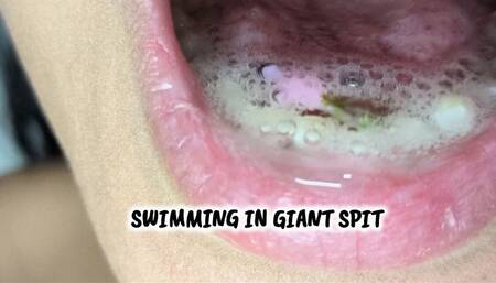giant makes tiny man swim in his spit