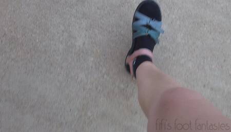 Fifi driving in Teva sandals with black Nike socks replay