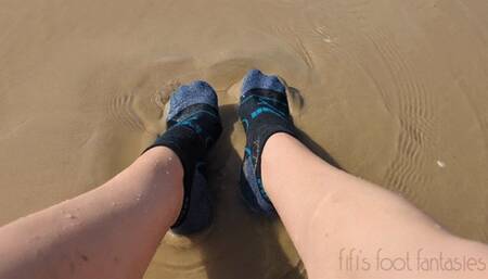Fifi getting her socks all sandy and wet on the beach replay