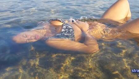 Invisible energy dunks me as I wash my hair in the sea