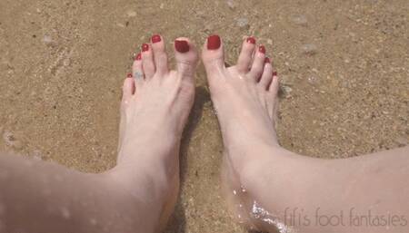 Fifi showing off her feet in the sand and waves at the beach replay