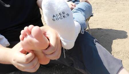 Chinese woman's feet are tickled by the river
