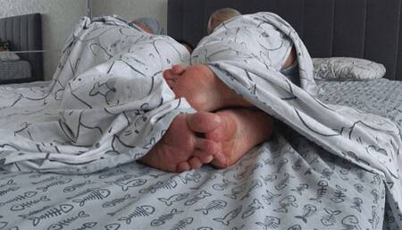 Flirting with legs under the sheets a