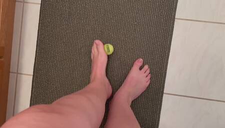 Size 12 feet, long toes picking up a small tennis item, Foot fetish