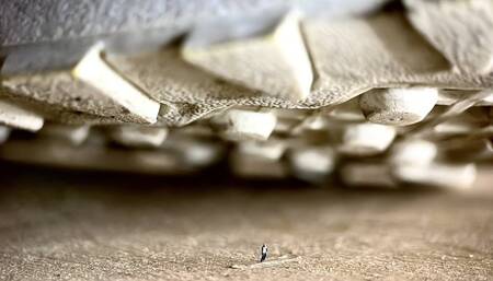 Sneakers and dirty socks of a giantess loom over a tiny guy