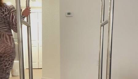 Carissa playing on the luggage cart in the Zebra catsuit!