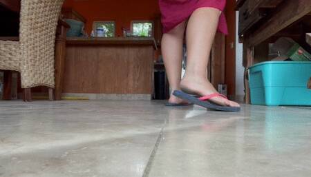 Dirty feet in flip-flops walking around in a cute sarong