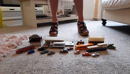 Back by popular demand GIANTESS Charn crushes small cars, buildings, buses in black wedge sandals closeup view