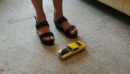 GIANTESS Charn crushes a yellow Ford Boss Mustang in black wedges closeup left view