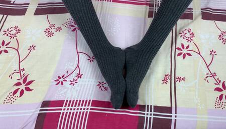 Girl in Gray Long Socks on Her Legs Caresses Herself in Bed