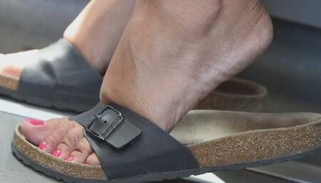 Foot fetish slippers dangling close-up