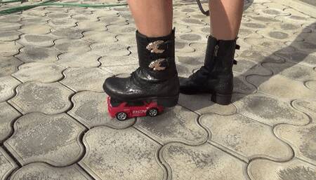 Crushed a toy car with black boots BD