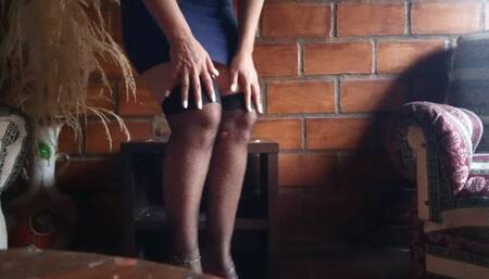 Beautiful woman sitting cross-legged, fishnet stockings and very high hanging heels (3)