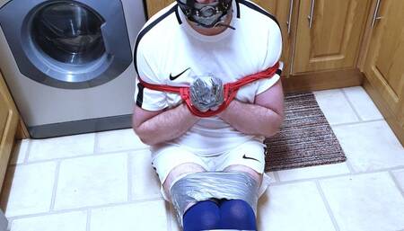 Footballer duct taped on kitchen floor 2