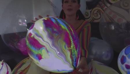 Belle has fun popping light-up balloons