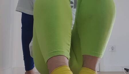 Clown playing with feet and putting on rubber gloves on feet