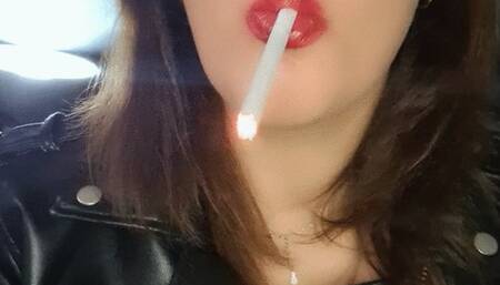 The smoky scent clings to her, mingling with the leather