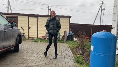 A girl in high-heeled boots decided to get them knee-deep in dirt and mud