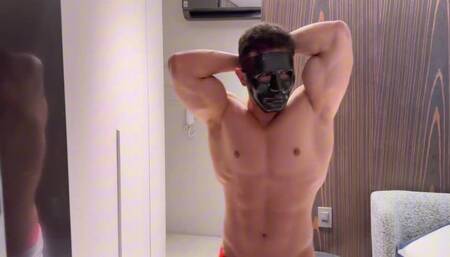 Muscle contraction of a hot masked young man