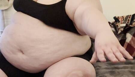 Massive immobile fatty fights against her huge sagging belly to try to touch her poor piggy feet — tries to sit up from lying down — panting and sweating and disabled by her own massive body — feedee SSBBW Marigold immobility can’t reach belly too big