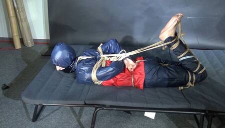 Myxxxy bound and gagged in shiny nylon Rainwear trying to free herself