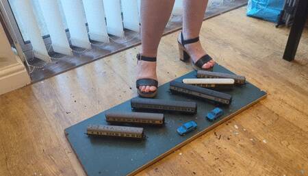 Giantess Lou crushes train coaches in big chunky heels left view