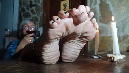 Rich crumpled soles covered with white cream under candlelight (1)