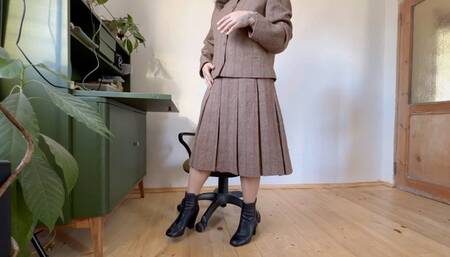 tacher in woolen costume toe tapping in leather boots avi