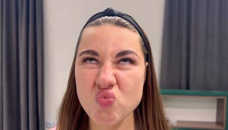 The girl tries to touch her nose with her lip, wrinkles her nose (custom video)