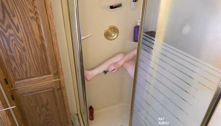 Womab shaving her body in the shower