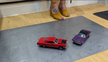 Giantess Atari queen destroys a Plymouth Road Runner & Dodge Challenger toy car crush in sexy yellow wedges close left view