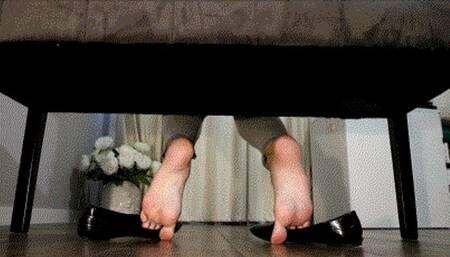 Shoe play , ballet flats gripped by the toes , wrinkled soles