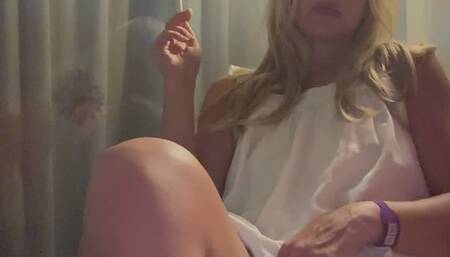 Blonde MILF smokes multiple corks, while playing with her pussy in public