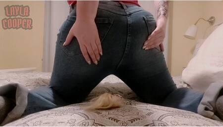 Giantess Layla Cooper sits on Barbie in jeans