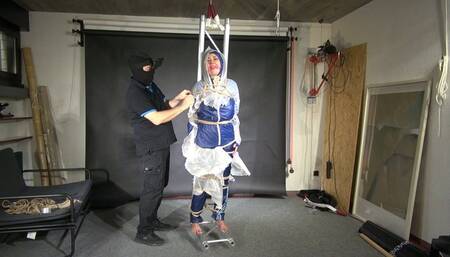 Alica bound and gagged in shiny nylon Rainwear and PVC which is ropped off