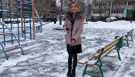 a girl plays on a summer playground in winter at -15 barefoot in stockings and a dress (reupload)