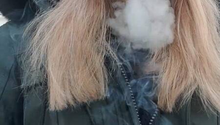 Smoking a cigarette outside with my green jacket