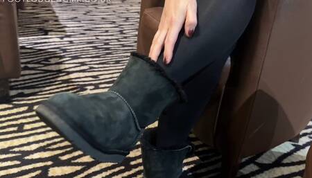 Amelie wearing black tights and removing her Uggs