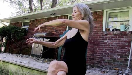 Lilly sitting on the deck, running her fingers through her long granny hair